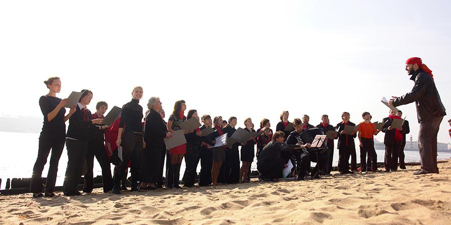 The St Petersburg Choir of Complaints performing on the beach.